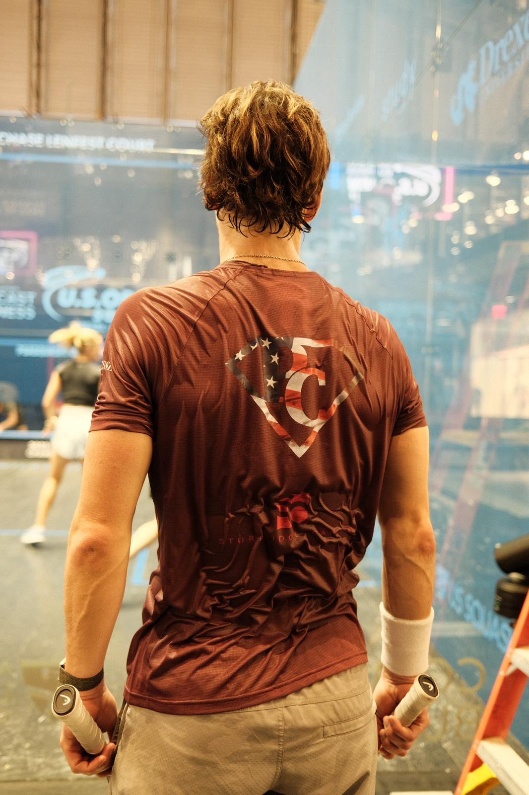 Paul Coll Superman limited edition squash shirt –  XTPro performance fabric in Burgundy walking off the court after his match.