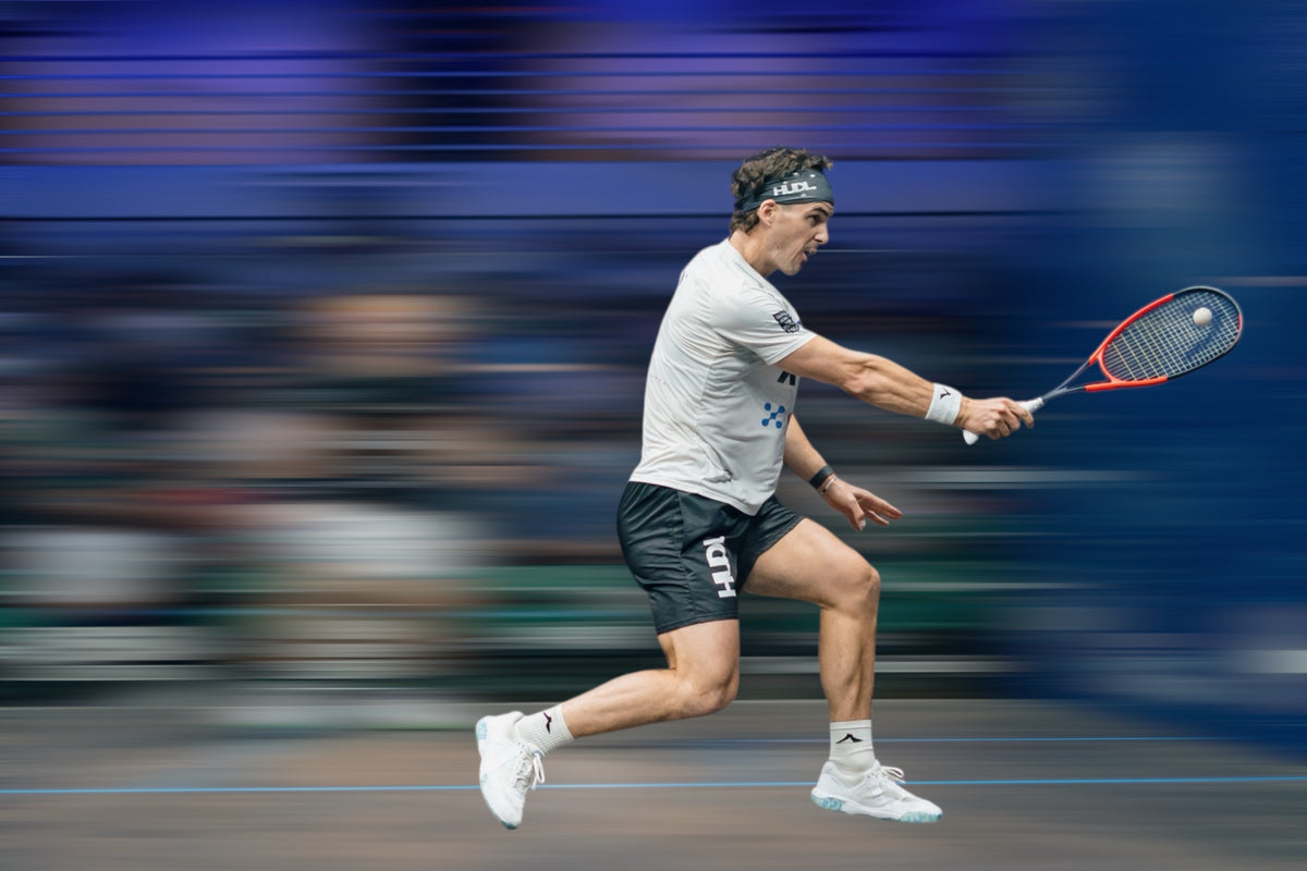 Action shot of Paul Coll wearing HUDL men's squash performance shorts – 2-in-1 design, XTPro moisture-wicking fabric