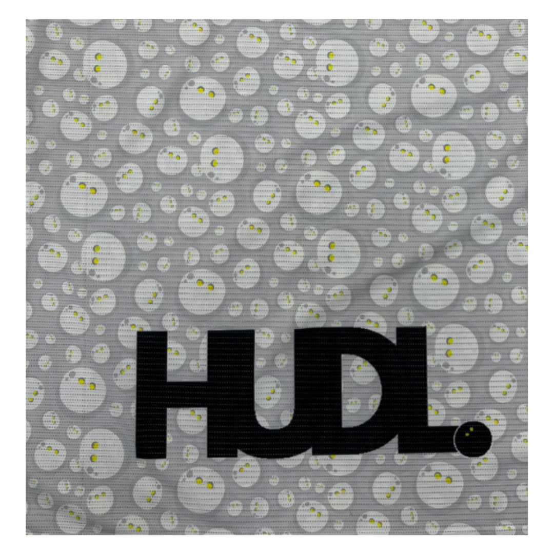 close up of the HUDL Rally in Motion limited edition squash tee – XTPro silver infused performance fabric, unique graphic design in great with white squash balls 
